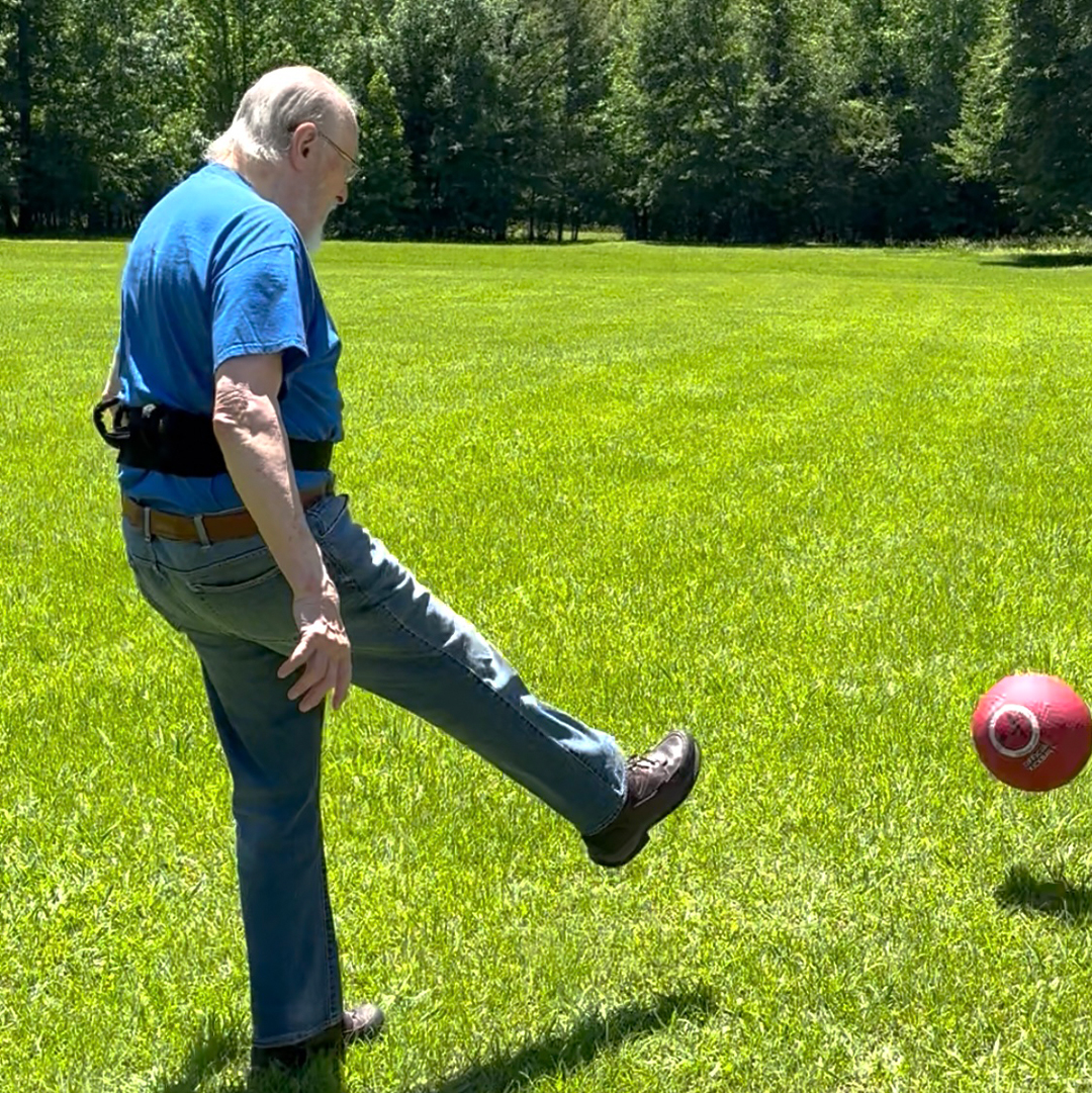 A man kicking a ball photo